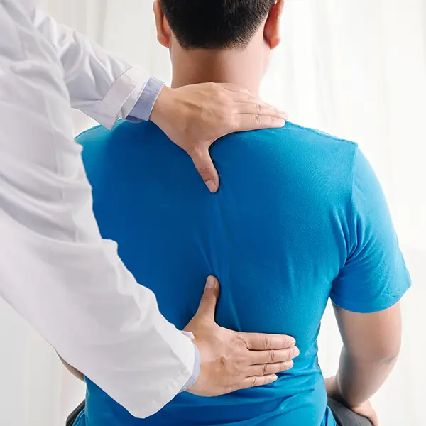 Image of doctor checking patient's spine