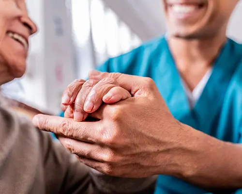 Provider holding patient hand